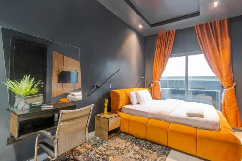 a bedroom with a bed and a desk and a window at One bedroom Maisonette Lekki in Lekki