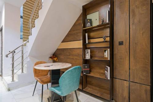 a dining room with a table and chairs and stairs at One bedroom Maisonette Lekki in Lekki