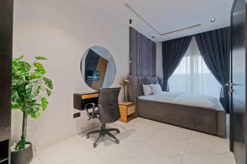 a bedroom with a bed and a desk and a mirror at One bedroom Maisonette Lekki in Lekki