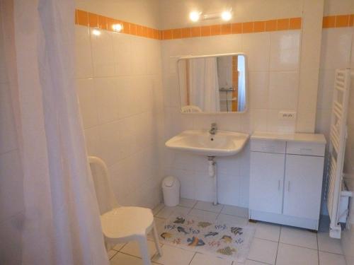 a bathroom with a sink and a mirror and a chair at Maison de campagne avec grande terrasse, près de Lavaudieu et accessible PMR - FR-1-582-217 in Mazerat-Aurouze