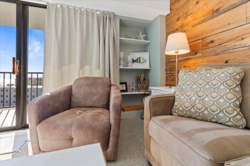 a living room with a chair and a desk at Ocean View 3BR Condo with Pool in North Ocean City in Ocean City