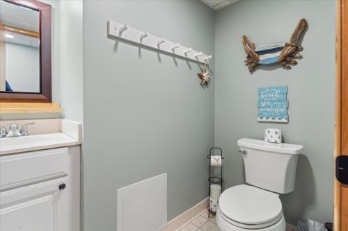 a bathroom with a toilet and a sink at Ocean View 3BR Condo with Pool in North Ocean City in Ocean City