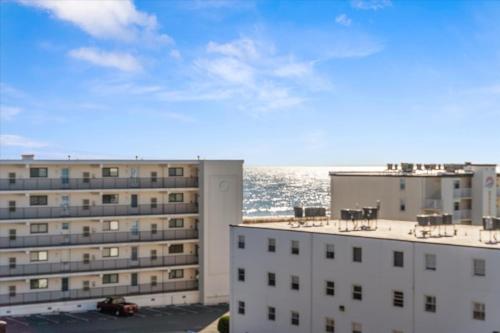 a view of two buildings with the ocean in the background at Ocean View 3BR Condo with Pool in North Ocean City in Ocean City