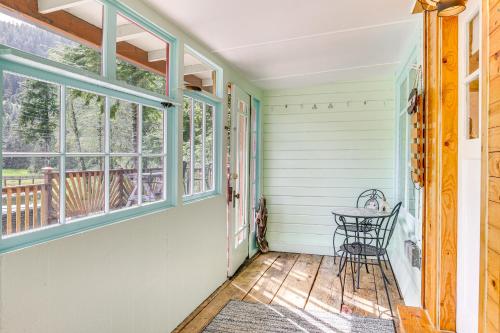 a porch with a table and windows at Salmon Return and Wildlife Roam Ketchikan Getaway! in Ketchikan