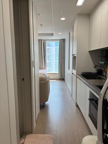 a kitchen with a couch and a chair in a room at g HOUSE in Busan