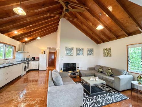 a living room with a couch and a table at Are Ara - House of Pineapple in Titikaweka