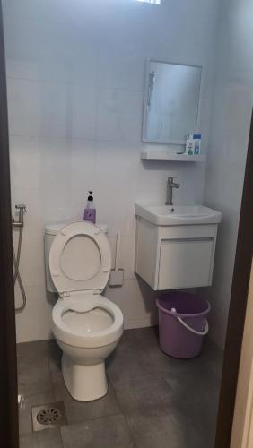 a bathroom with a white toilet and a sink at Homestay H&H in Cyberjaya