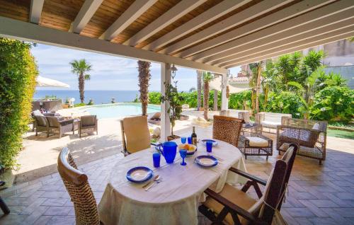 a table on a patio with a view of a pool at Villa Oceania in Mandra Capreria