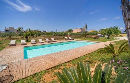 a swimming pool in a yard with lounge chairs at Amazing Home In Marsala With Wifi in Marsala