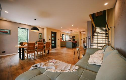 a living room with a couch and a dining room at Villa George in Bribir