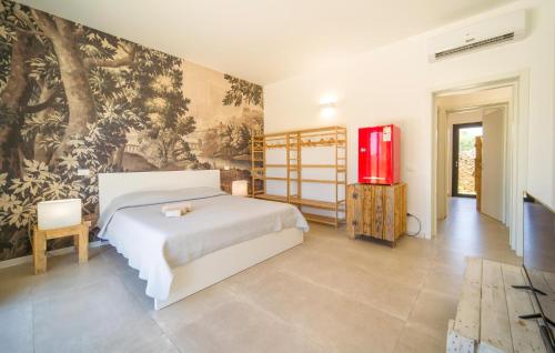 a bedroom with a bed and a painting on the wall at Amazing Home In Marsala With Wifi in Marsala