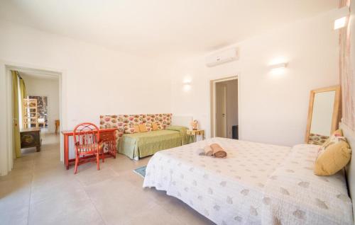a bedroom with two beds and a table and a chair at Amazing Home In Marsala With Wifi in Marsala
