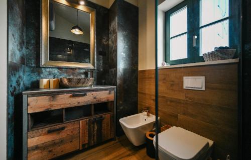 a bathroom with a sink and a toilet and a mirror at Villa George in Bribir