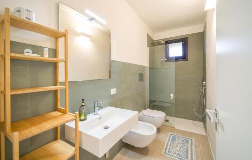 a bathroom with a white sink and a toilet at Amazing Home In Marsala With Wifi in Marsala