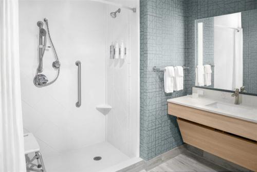 a white bathroom with a shower and a sink at Homewood Suites by Hilton Fayetteville in Fayetteville