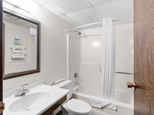 a bathroom with a sink and a toilet and a shower at Super 8 by Wyndham Ogallala in Ogallala