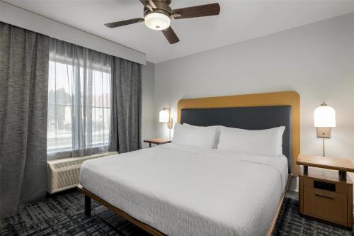 a bedroom with a bed and a large window at Homewood Suites by Hilton Slidell in Slidell