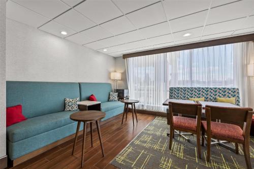 a living room with a couch and a table at Hampton Inn Toledo-South/Maumee in Maumee