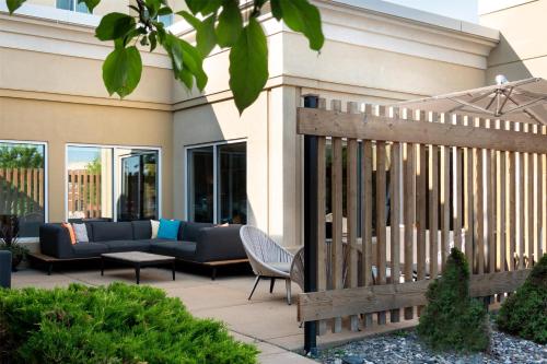 a patio with couches and a wooden fence at Hilton Garden Inn Billings in Billings