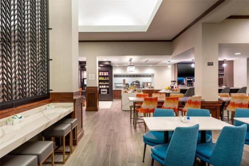 a dining room with tables and chairs at Hilton Garden Inn Billings in Billings