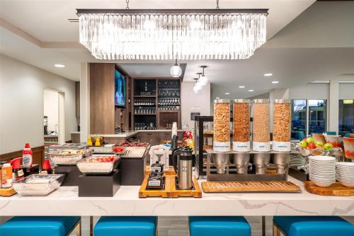 a buffet line in a restaurant with a chandelier at Hilton Garden Inn Billings in Billings