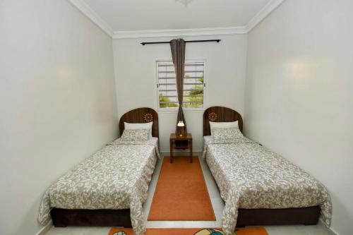 Voodi või voodid majutusasutuse Jardin de chrifia cosy toas