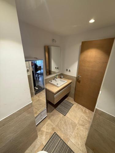 een badkamer met een wastafel en een spiegel bij 1 Bedroom at Marassi Marina in El Alamein