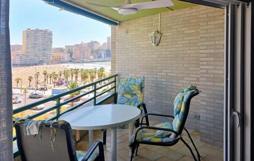 a balcony with a table and chairs and a view of the city at Stunning Apartment In Oropesa Del Mar in Oropesa del Mar