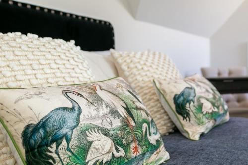 two pillows sitting on a bed with at Field House - Stunning 3 Bedroom Home in Kingham! in Kingham