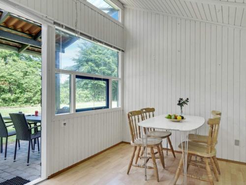 a dining room with a white table and chairs at 4 person holiday home in Hampen in Hampen
