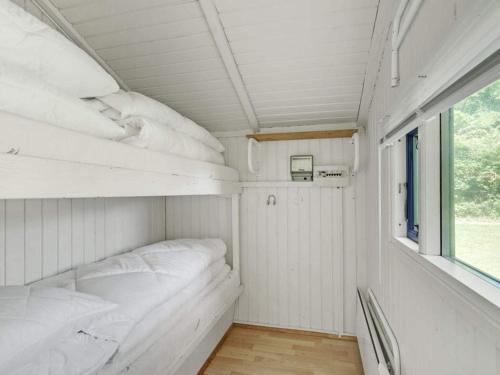 a small room with white pillows and a window at 4 person holiday home in Hampen in Hampen