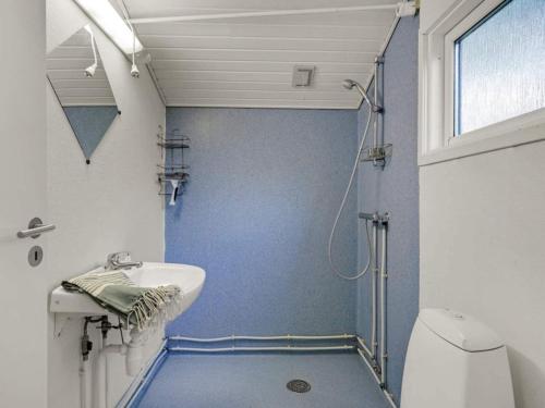 a bathroom with a shower and a sink and a toilet at 4 person holiday home in Hampen in Hampen
