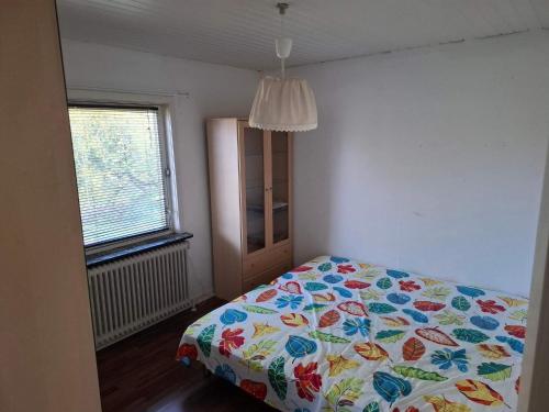 a bedroom with a bed with a colorful comforter at 6 person holiday home in Borre in Borre