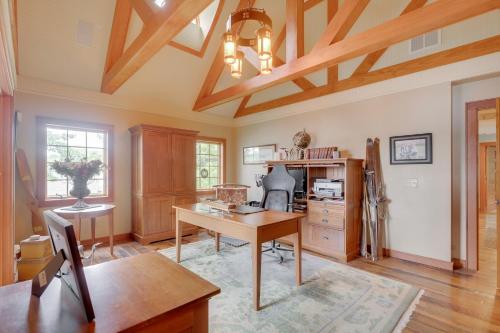 a large room with a desk and a table at Luxe Family Home on Orange Lake with Private Dock! in Newburgh