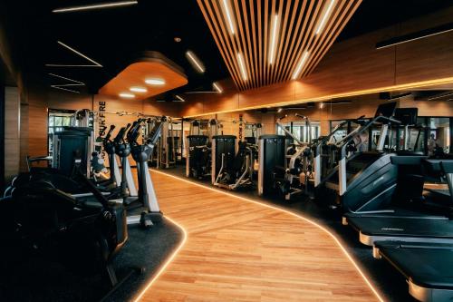 a gym with treadmills and elliptical machines at Renaissance Wind Creek Aruba Resort in Oranjestad