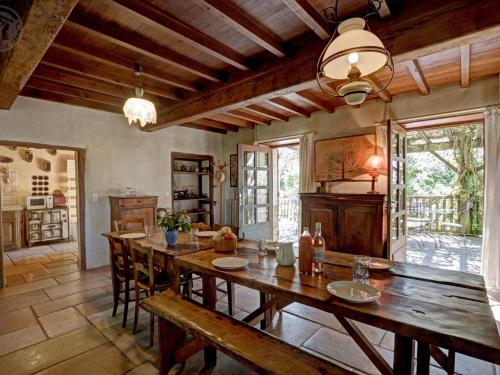 a large dining room with a wooden table and chairs at Découvrez ce gîte champêtre avec spa, sauna, piscine et jardin privatif à Essertines-en-Donzy - FR-1-496-200 in Essertines-en-Donzy