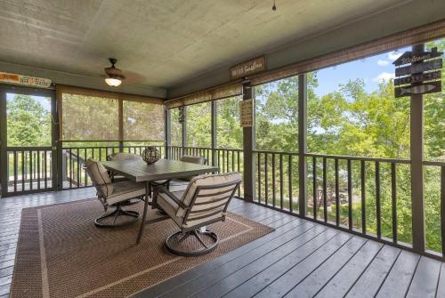 a screened in porch with a table and chairs on it at Updated Cabin - Hiwassee Highlife in Decatur
