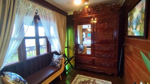 a living room with a bench and a window at The Bukit Resort Langkawi in Kampung Padang Masirat