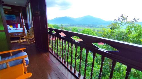a balcony with a view of the mountains at The Bukit Resort Langkawi in Kampung Padang Masirat