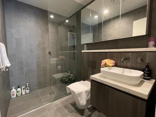 a bathroom with a sink and a shower at Nearby stadium & New 3b2b Apt & Free parking in Sydney