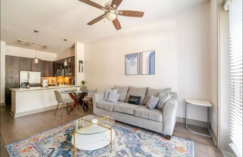 a living room with a couch and a kitchen at Apartment in Downtown Houston Free Parking in Houston