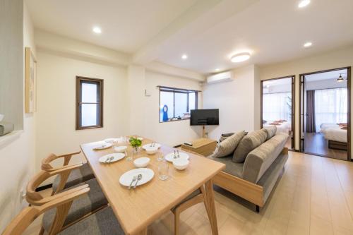 a living room with a table and a couch at Akabane Nishi Masuda House in Tokyo