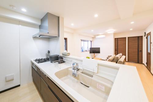 a kitchen with a white counter top in a room at Akabane Nishi Masuda House in Tokyo