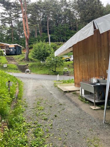 a building with a sink next to a road at Retreat Camp Mahoroba in Fujikawaguchiko