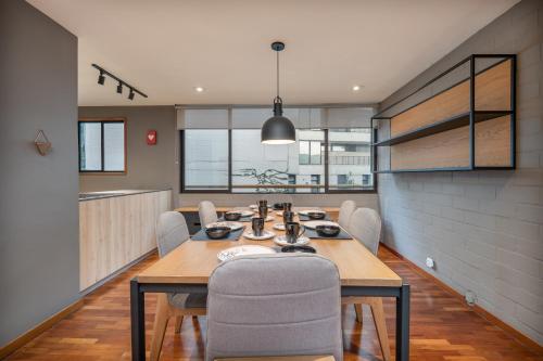 a dining room with a table and chairs at beautiful 2 bedroom luxury condo in Provenza in Medellín