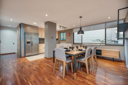 a kitchen and dining room with a table and chairs at beautiful 2 bedroom luxury condo in Provenza in Medellín