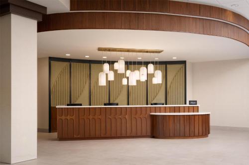 a lobby with a reception desk and chandelier at Embassy Suites North Charleston Airport Hotel Convention in Charleston