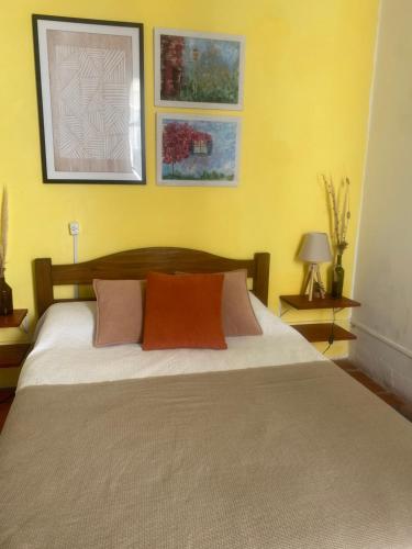 a bedroom with a bed with two pillows on it at Casa Calma in Colonia del Sacramento