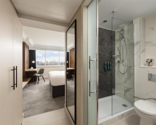 a bathroom with a shower and a toilet at Hilton London Metropole in London