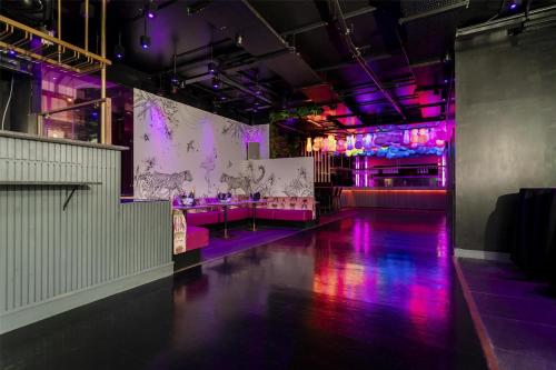 a room with purple lights and a dance floor at Hilton Liverpool City Centre in Liverpool
